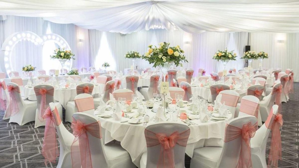 A function suite at Brandon Hall Hotel and Spa laid with round tables and flowers